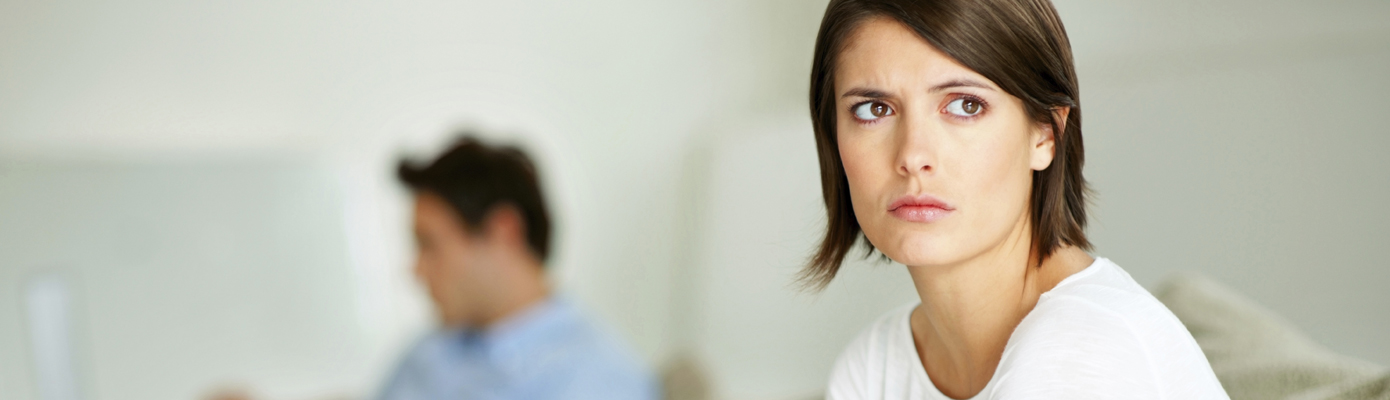 woman thinking with man in background